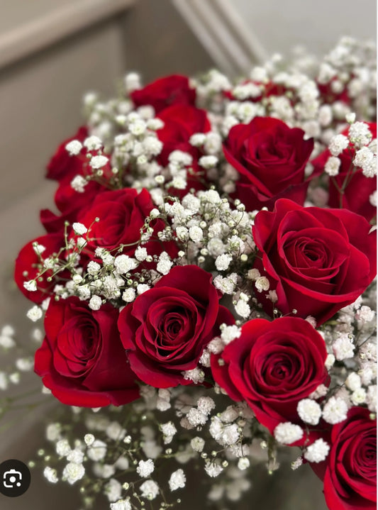 12 red roses wrapped with decorative festive filler